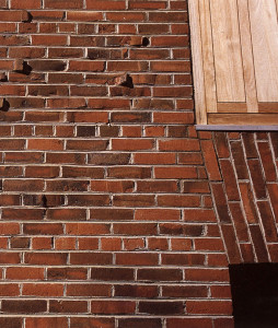 Figure 9: Exeter Library, detail of exterior façade.  Note the miscut bricks casting shadows and the jack arch that seamlessly widens the openings.