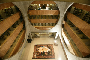 Figure 11: Exeter Library, interior.  The main entryway goes up the double spiral stairs, center, into the atrium.  Students meet at the large table in the atrium before working on research for classes, especially history.  